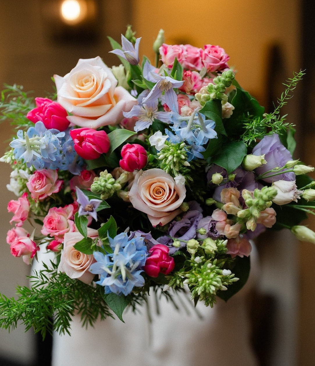 The Daydream bouquet by Mad Lilies featuring premium roses and seasonal flowers in blush pink, powder blue and white, hand-tied in our signature naturally abundant style.