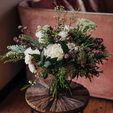 The Midnight Pearl luxury white winter hand-tied bouquet featuring White Tibet roses, lisianthus, waxflower and pussy willow, created by Mad Lilies florists.