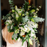White Oriental lily bouquet with seasonal white flowers and fresh green foliage, hand-tied in a natural garden style.