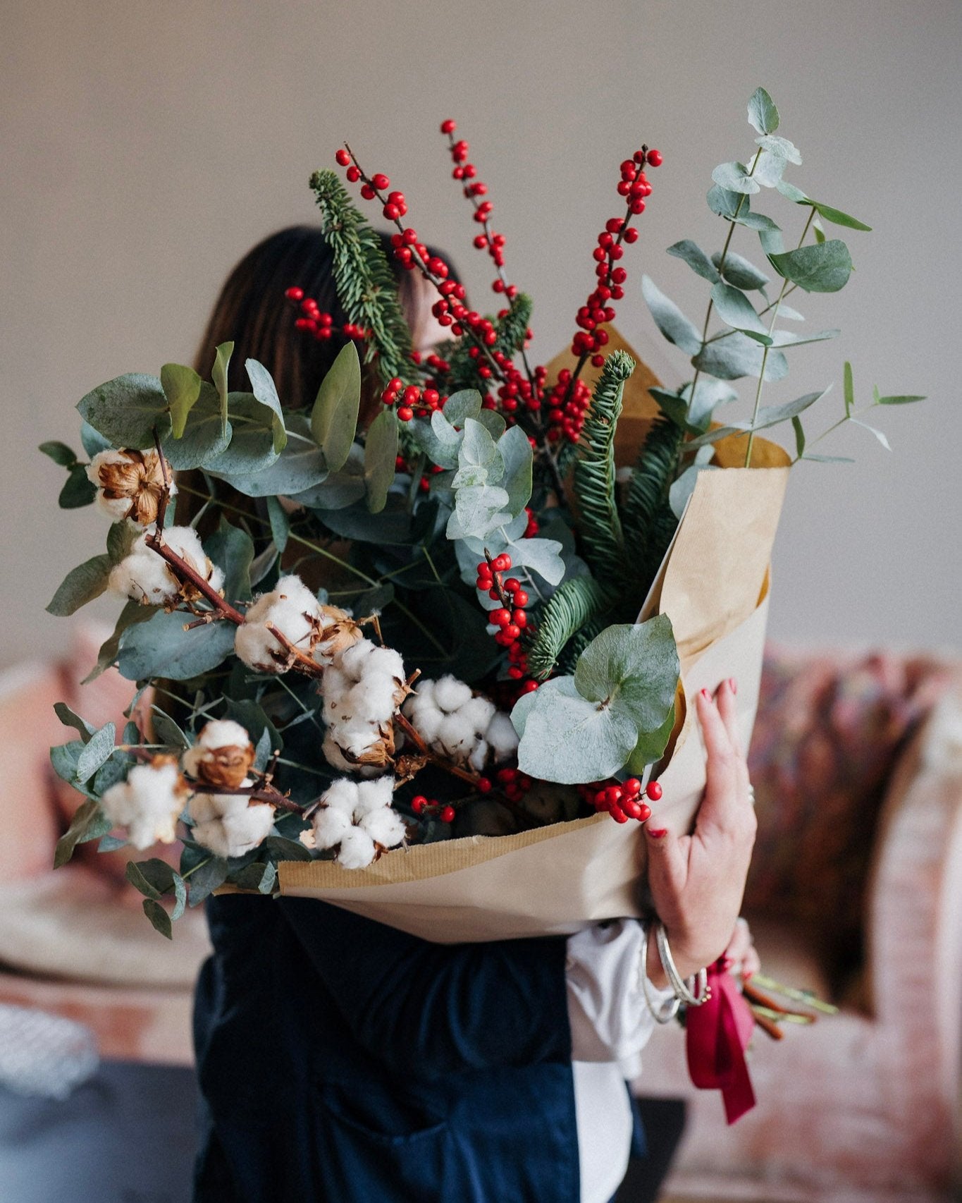 The Nordic Jewel fresh Christmas foliage and winter stem bunch featuring eucalyptus, red Ilex berries, festive pine and soft cotton, wrapped in kraft paper with ribbon.