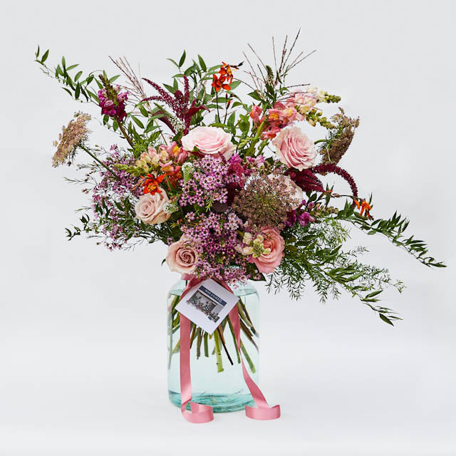 The Seasonal Vase by Mad Lilies, featuring a beautifully arranged selection of fresh seasonal flowers and foliage in a stylish glass vase.