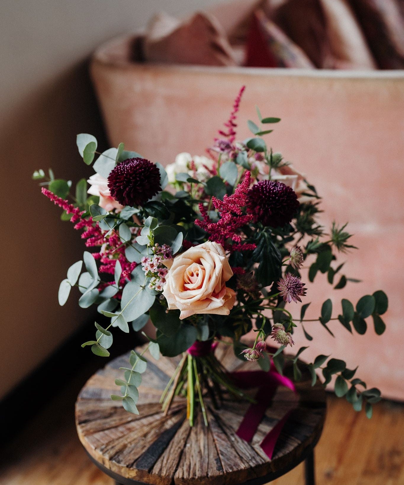 The Velvet Kiss luxury Christmas flower posy with Mother of Pearl roses, damson blooms, mulberry astilbe, astrantia, blush waxflower, white thistles and eucalyptus.