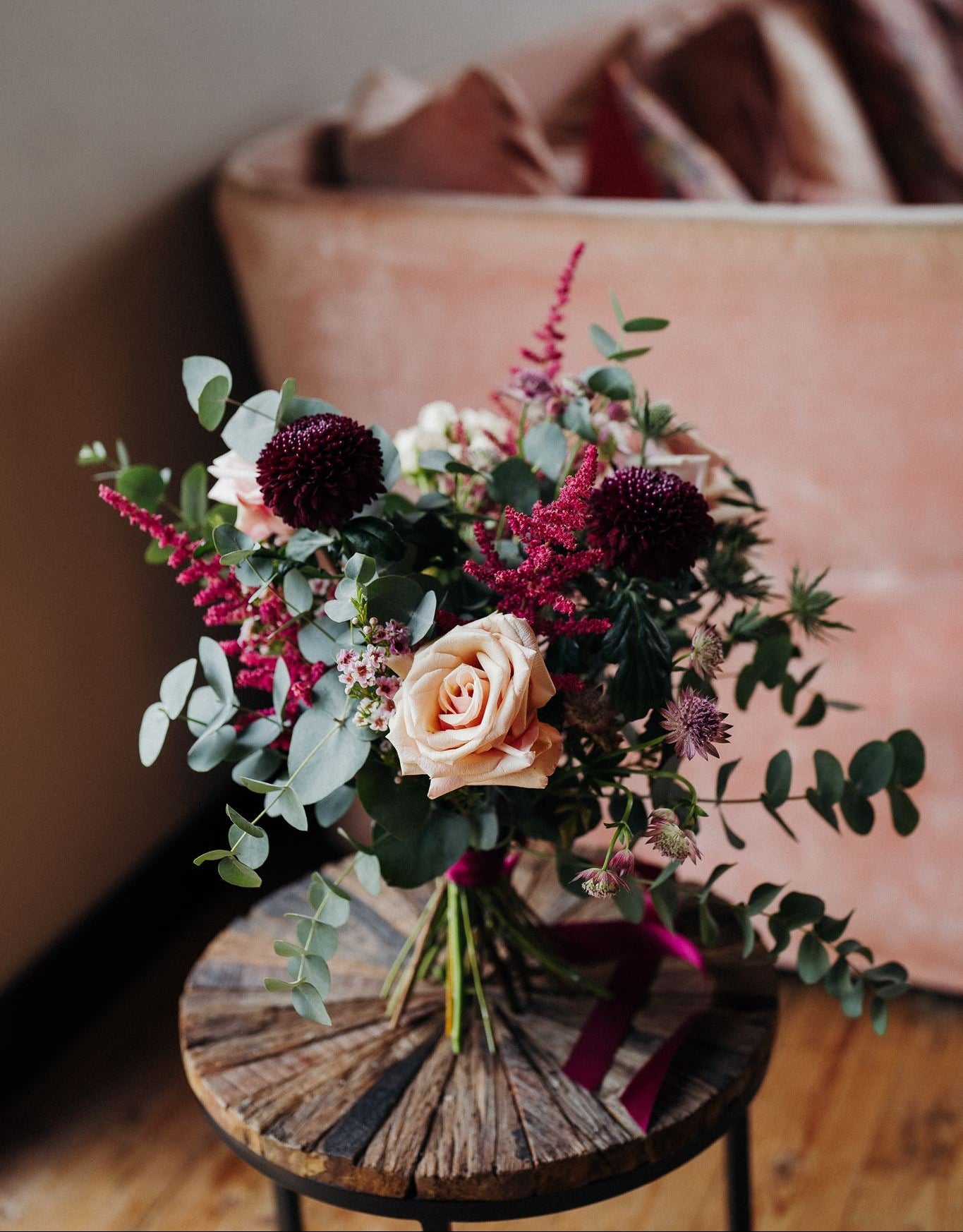 The Velvet Kiss luxury Christmas flower posy with Mother of Pearl roses, damson blooms, mulberry astilbe, astrantia, blush waxflower, white thistles and eucalyptus.