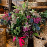 The Wild Revelry, a luxury Christmas hedgerow vase with jewel-toned flowers, thistles and sculptural seedheads. Handcrafted by Mad Lilies in Surrey.