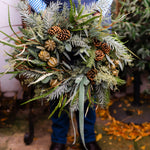 The Wildwood fresh Christmas door wreath with pine, eucalyptus, seasonal green foliage, natural pinecones, dried limes and velvet ribbon.