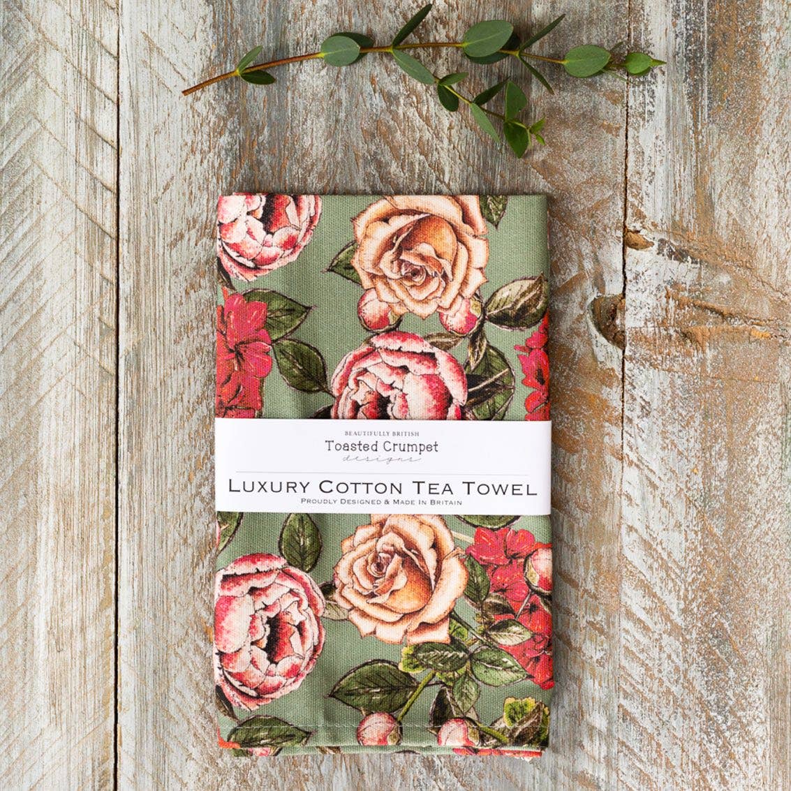Toasted Crumpet In Full Bloom Vintage Green botanical tea towel featuring Jo Clarke's hand-painted floral illustrations inspired by the British countryside.