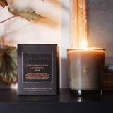 True Grace Portobello Oud luxury scented candle in a smoked glass vessel, hand-poured in England with natural vegetable wax and warm woody fragrance.