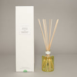 True Grace Rosemary and Eucalyptus reed diffuser in etched glass with fresh botanical home fragrance.