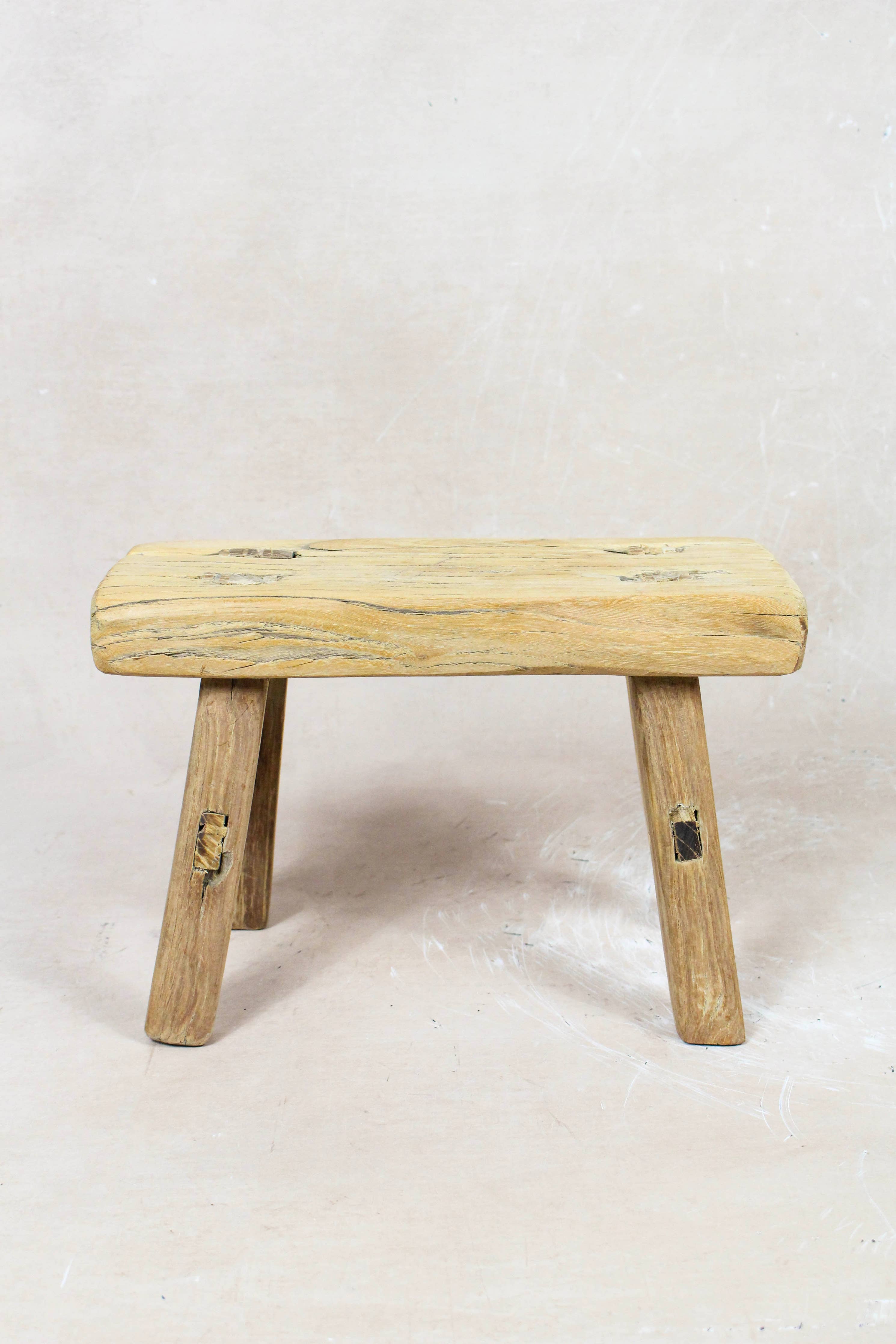 Shop our Vintage Elm Wood Stool, handcrafted from 80–100-year-old reclaimed elm. Each rustic wooden stool has its own unique grain, patina and character.