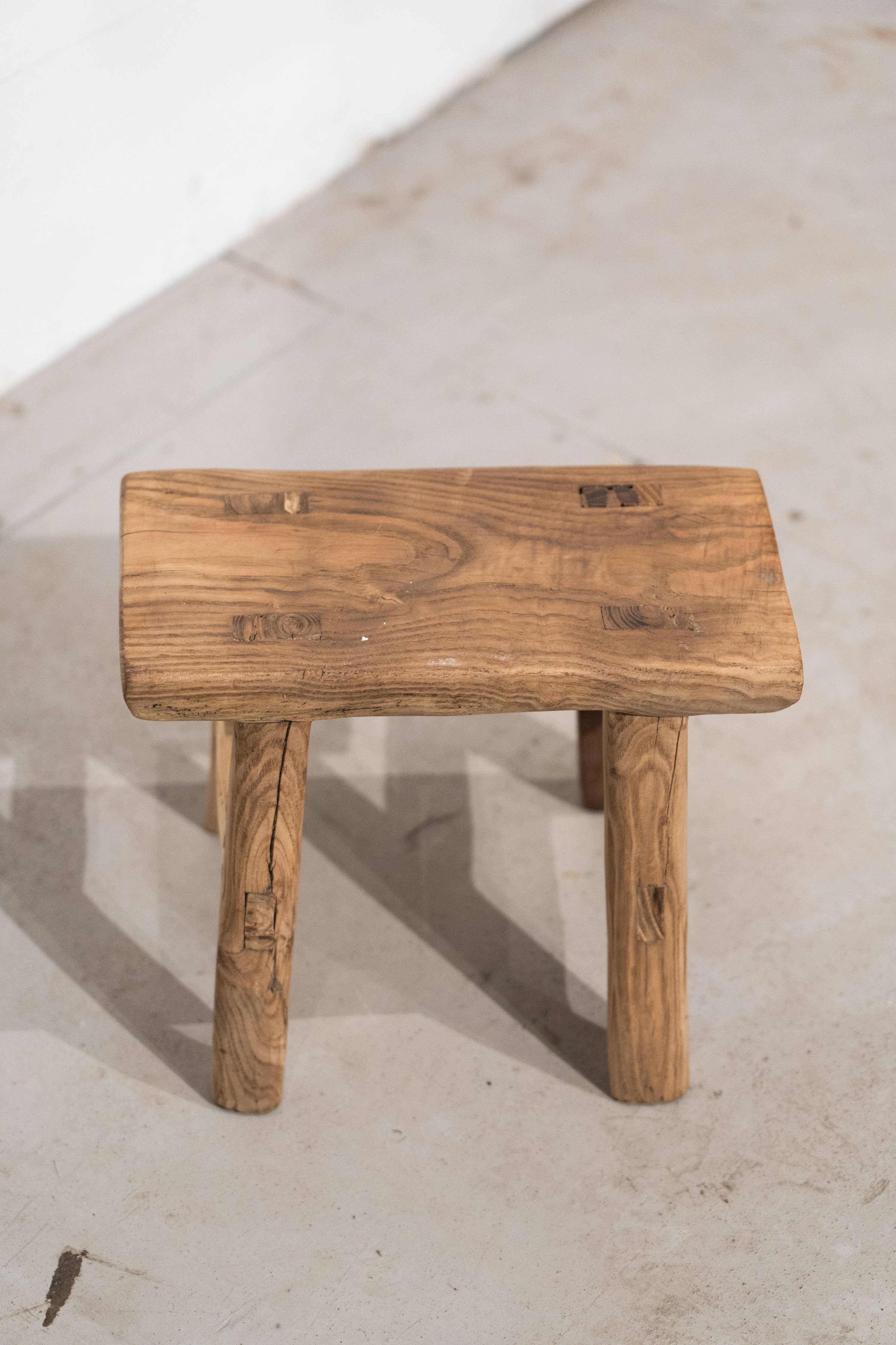 Shop our Vintage Elm Wood Stool, handcrafted from 80–100-year-old reclaimed elm. Each rustic wooden stool has its own unique grain, patina and character.