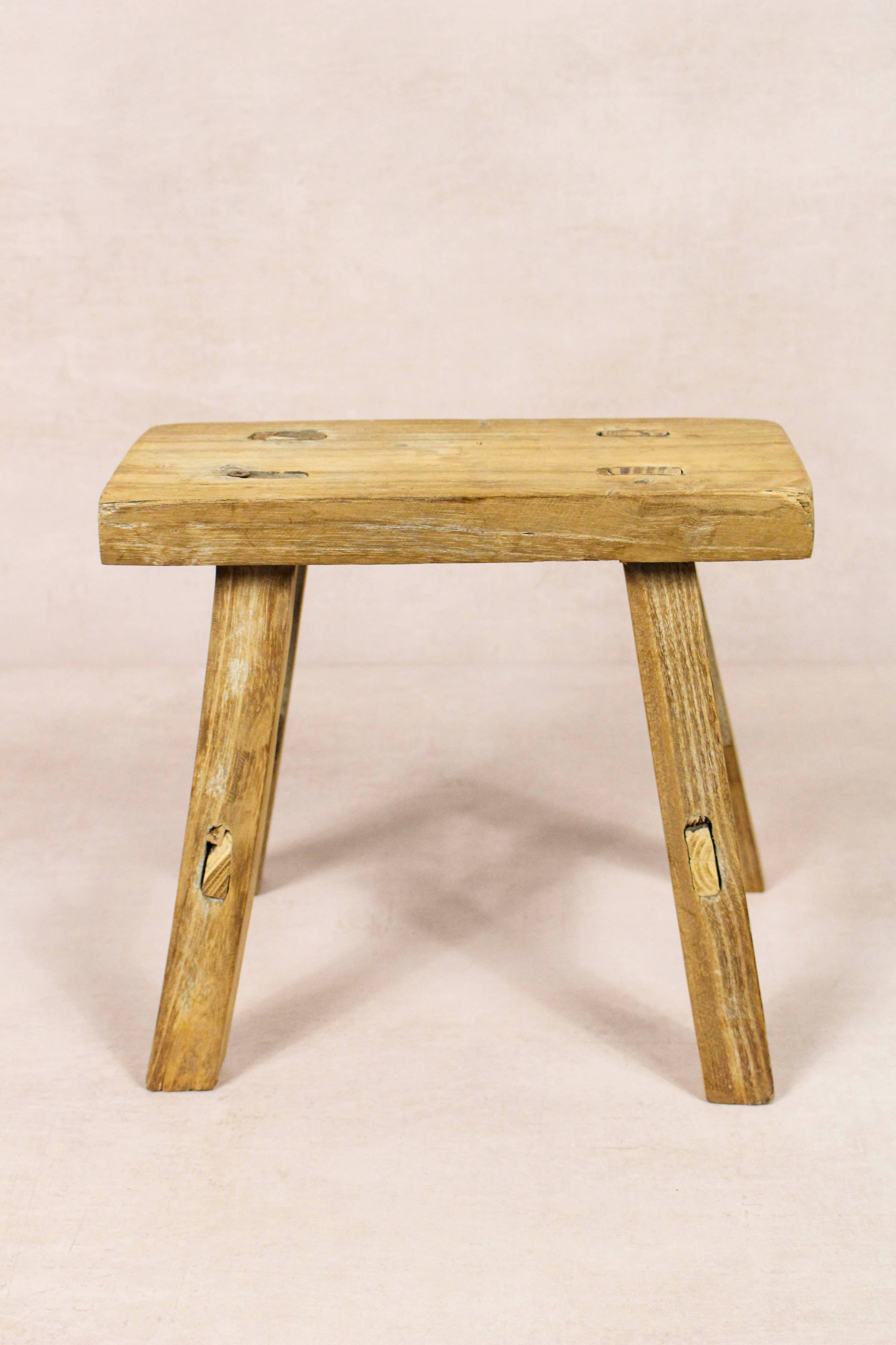 Shop our Vintage Elm Wood Stool, handcrafted from 80–100-year-old reclaimed elm. Each rustic wooden stool has its own unique grain, patina and character.