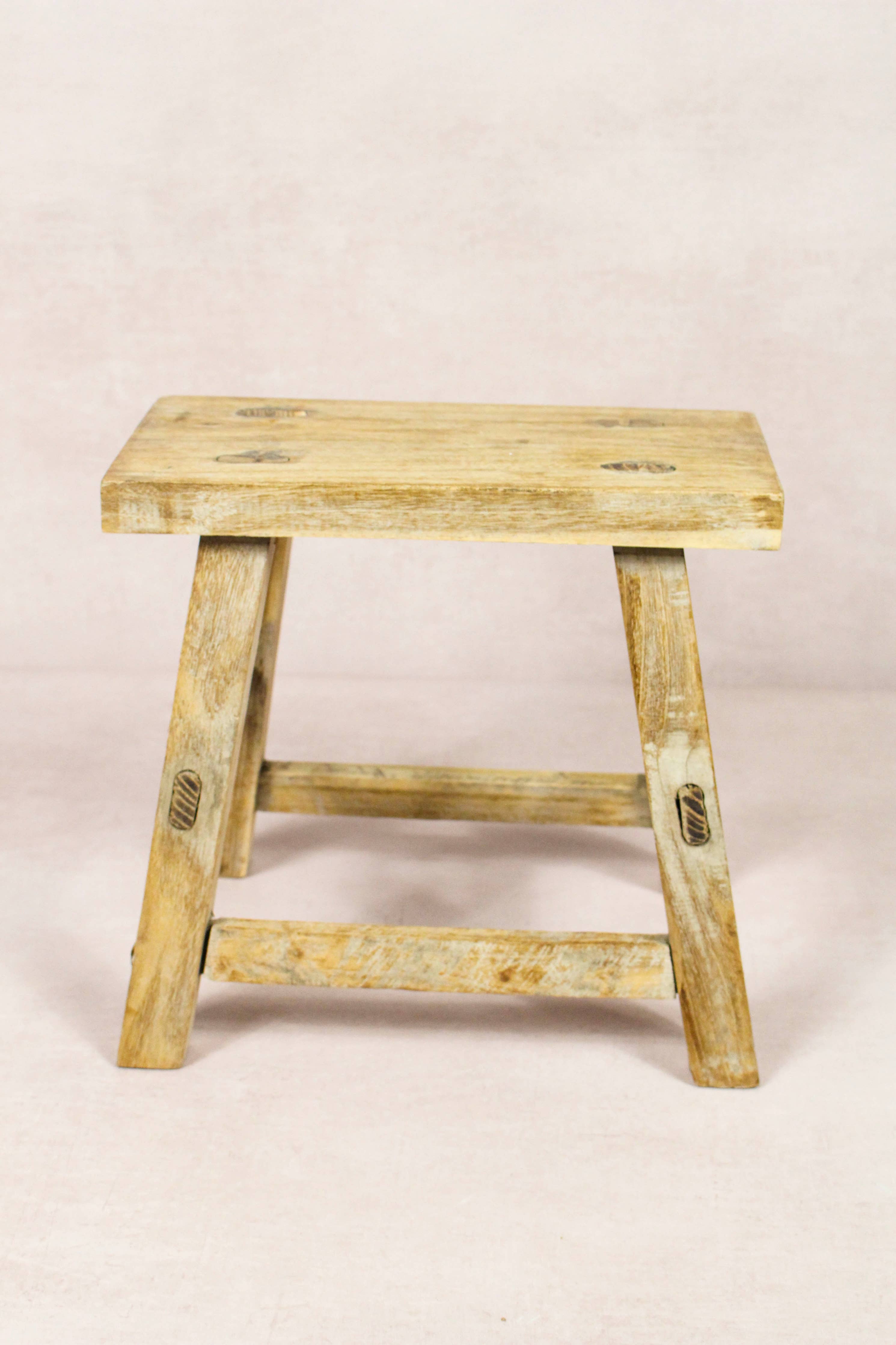 Shop our Vintage Elm Wood Stool, handcrafted from 80–100-year-old reclaimed elm. Each rustic wooden stool has its own unique grain, patina and character.