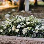 Natural garden-style casket spray funeral flowers featuring seasonal blooms and foliage, handcrafted by Mad Lilies florists in Banstead, Surrey.