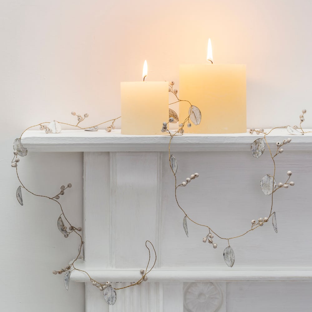 Style your home for Christmas with a white leaf and berry garland. Delicate metal leaves with gold highlights and wooden berries add an elegant festive touch.