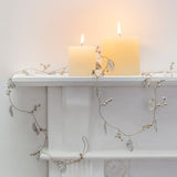 Style your home for Christmas with a white leaf and berry garland. Delicate metal leaves with gold highlights and wooden berries add an elegant festive touch.