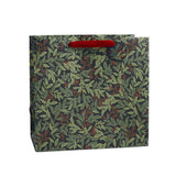 Rifle Paper Co. Willowberry Christmas gift bag featuring a festive botanical design, red velvet ribbon handles and coordinating gift tag.