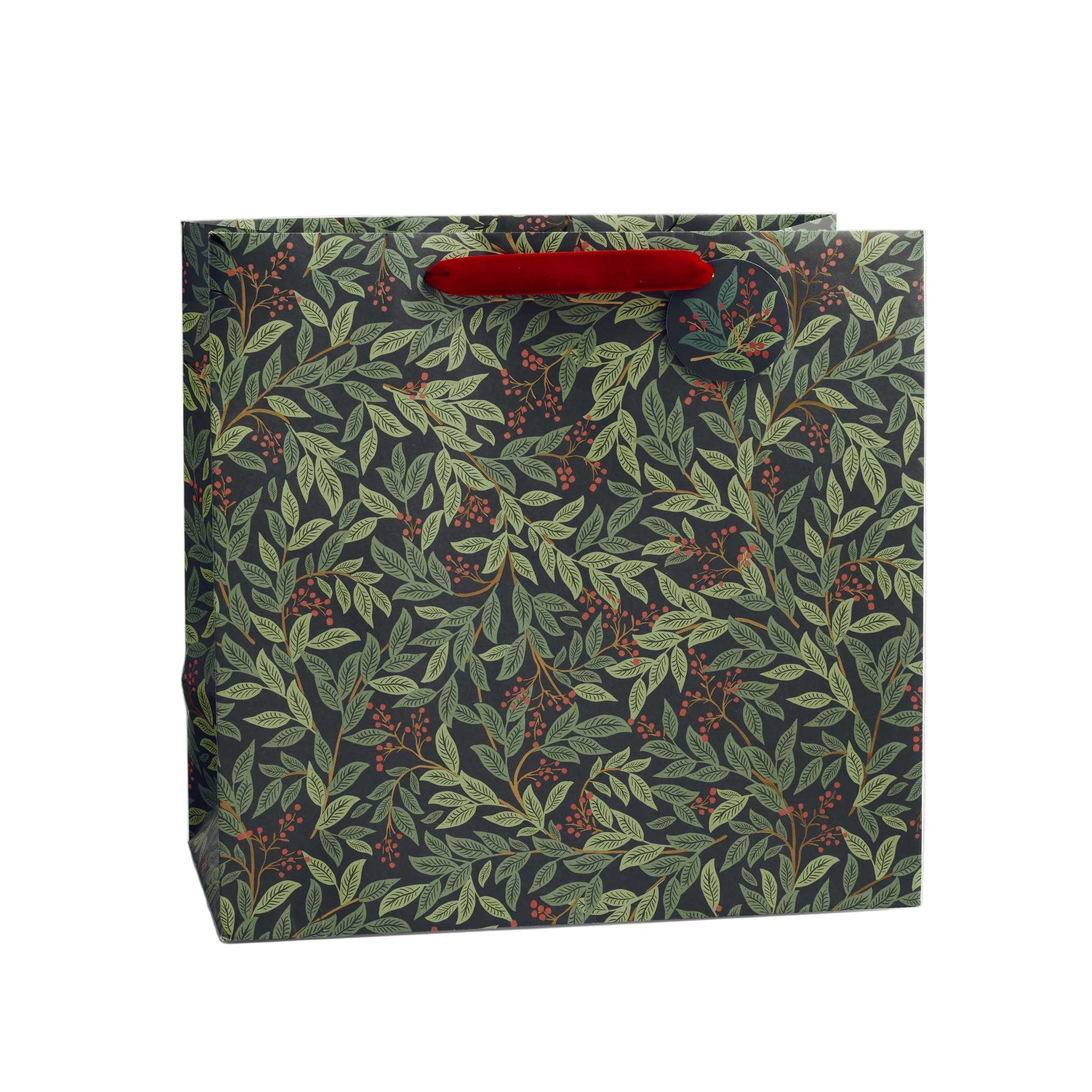 Rifle Paper Co. Willowberry Christmas gift bag featuring a festive botanical design, red velvet ribbon handles and coordinating gift tag.