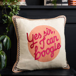 Yes Sir I Can Boogie Peach Cotton Slub Cushion in cream and peach on a sofa, featuring a playful slogan and textured cotton fabric.