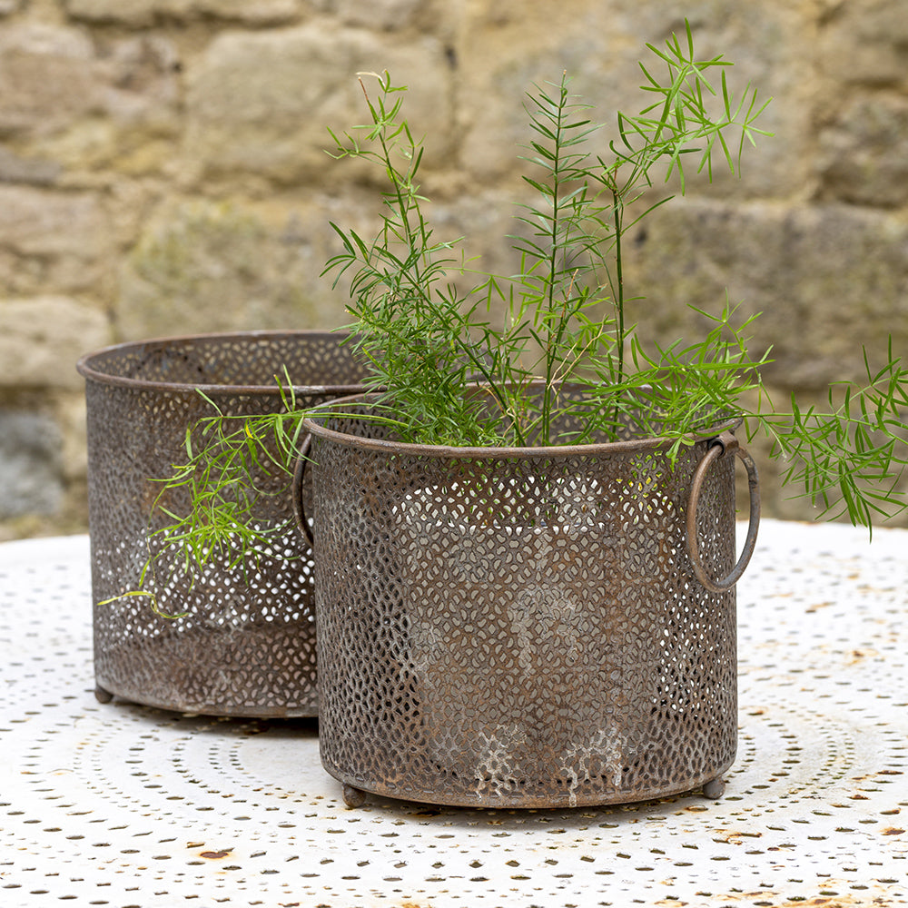 Two vintage metal lanterns with a perforated design 