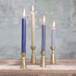 Nkuku Jahi brushed gold brass candlesticks in small and large sizes.