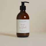 A pump bottle of Plum & Ashby Neroli & Bergamot Hand & Body Lotion on a beige background.