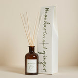 A Plum & Ashby Mandarin & Ginger diffuser with a glass vessel and reeds, displayed next to its packaging box.