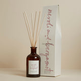 A Plum & Ashby neroli and bergamot diffuser with a recyclable glass vessel and wooden reeds, displayed alongside its packaging box.