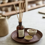 Plum & Ashby Wild Fig & Saffron Reed Diffuser with natural reeds in a recyclable glass bottle. A luxury home fragrance with wild fig, blackcurrant, saffron, amber, patchouli and vanilla, providing up to 8 weeks of warm, long-lasting scent.