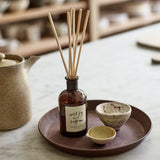 Plum & Ashby Wild Fig & Saffron Reed Diffuser with natural reeds in a recyclable glass bottle. A luxury home fragrance with wild fig, blackcurrant, saffron, amber, patchouli and vanilla, providing up to 8 weeks of warm, long-lasting scent.