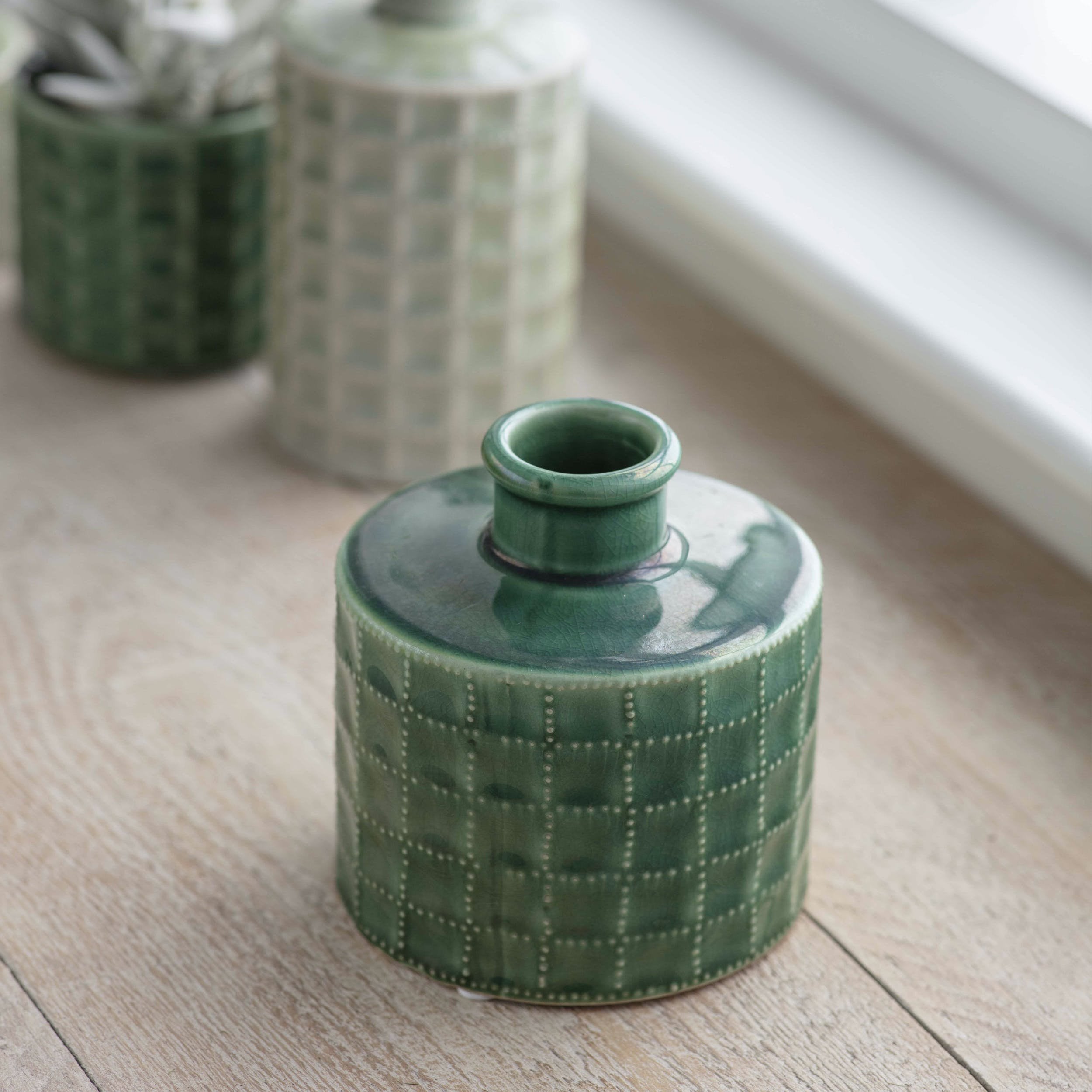 Sorrento Medium Ceramic Bottle in Foliage Green with glazed finish and unglazed rim.
